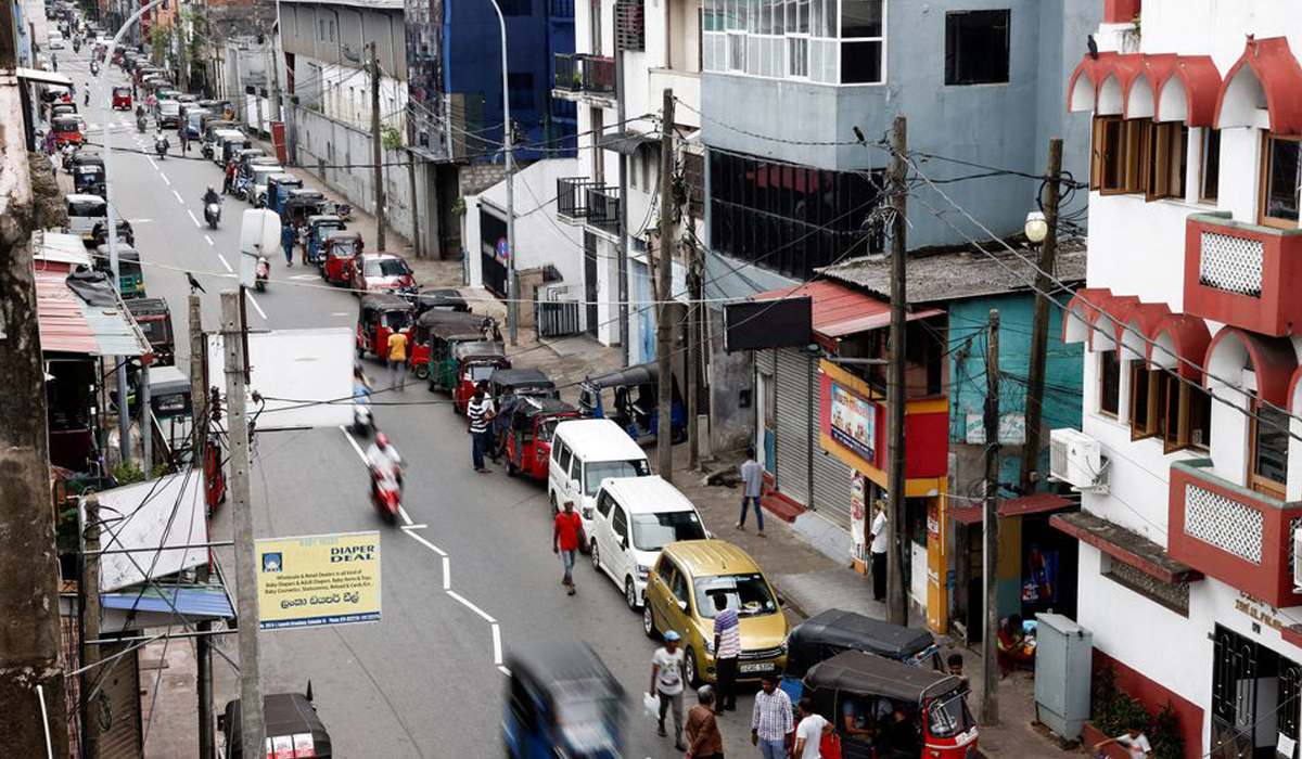 Vehicle owners wait in a queue